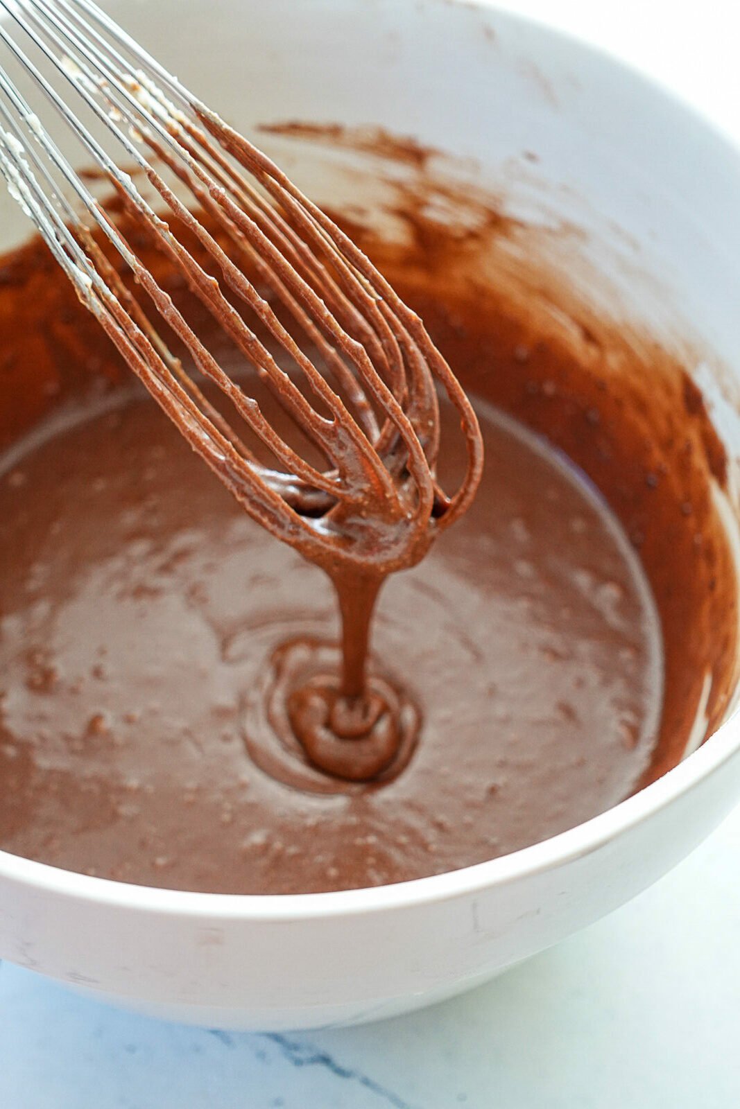 Chocolate Loaf Cake Batter in a bowl with a whisk