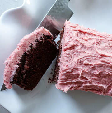 Knife Slicing Chocolate Loaf Cake Recipe with Strawberry Frosting
