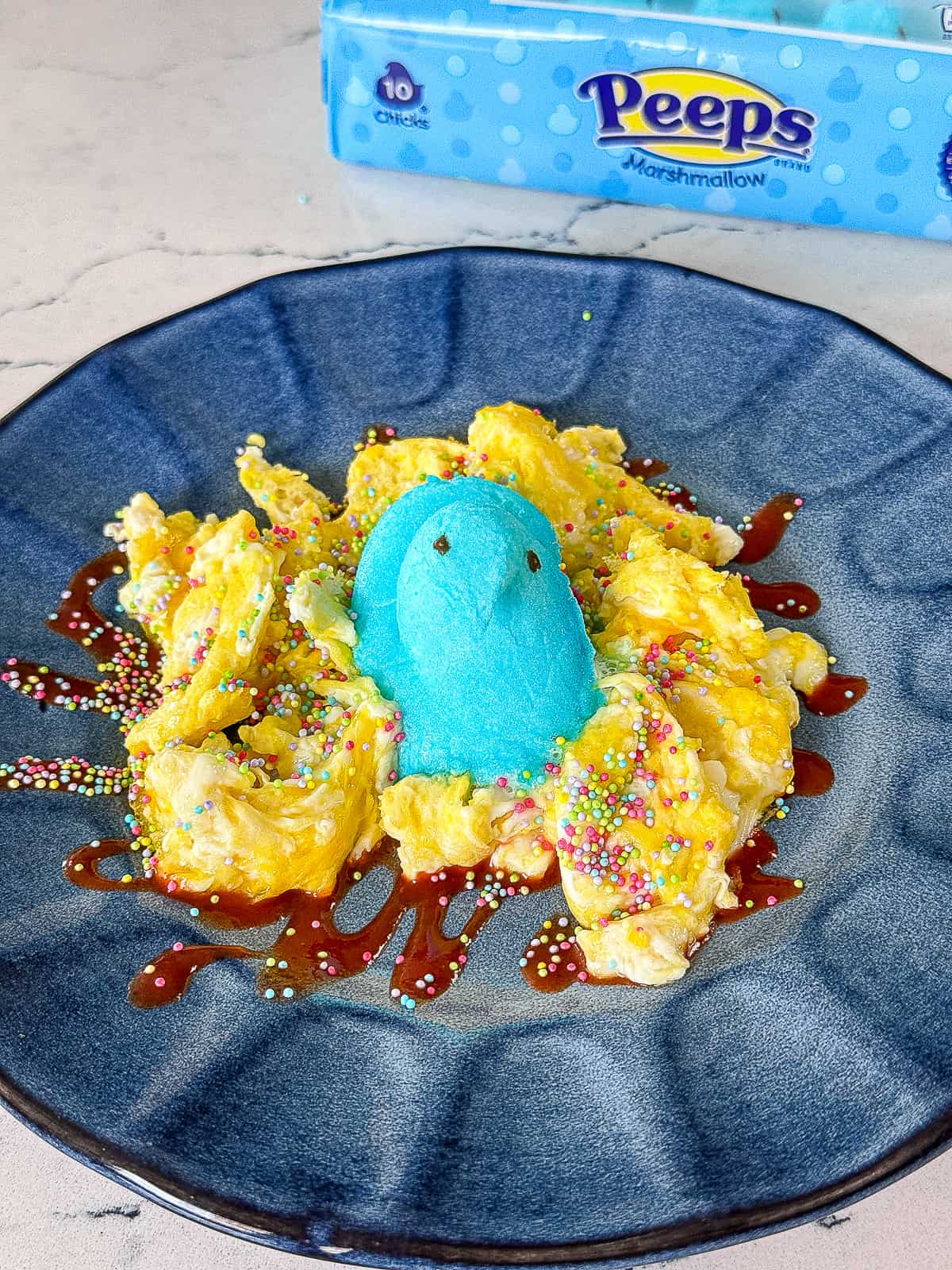 Peeps Marshmallows candy box with Easter brunch scrambled eggs topped with blue Peep