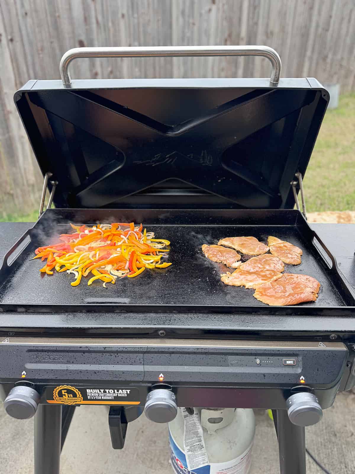 Traeger Flatrock Griddle Cooking BBQ Pineapple Chicken and Onions and Peppers