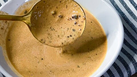 Close-up of creamy peppercorn steak sauce in a serving dish