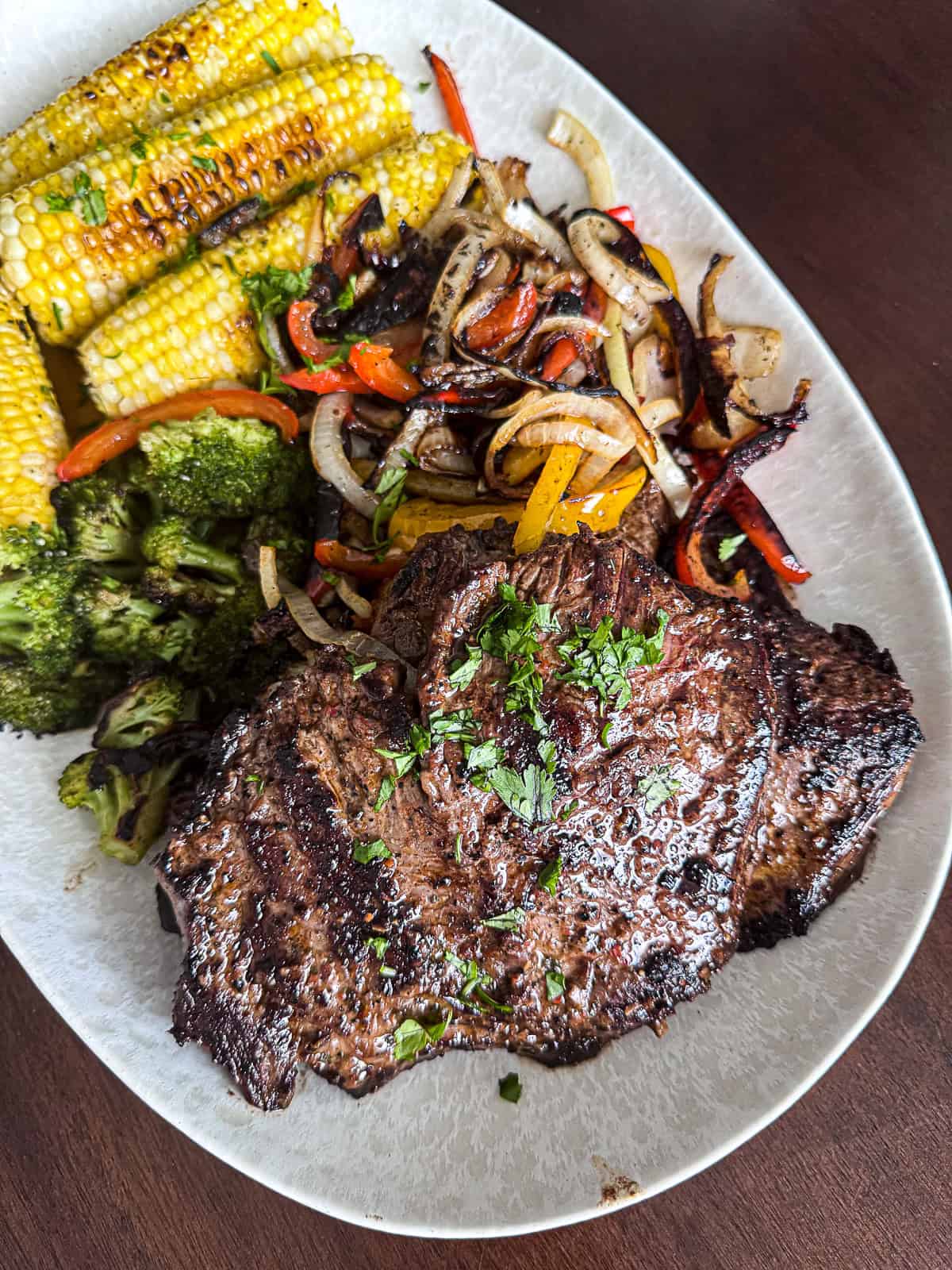 Griddled skirt steak family dinner on a serving platter