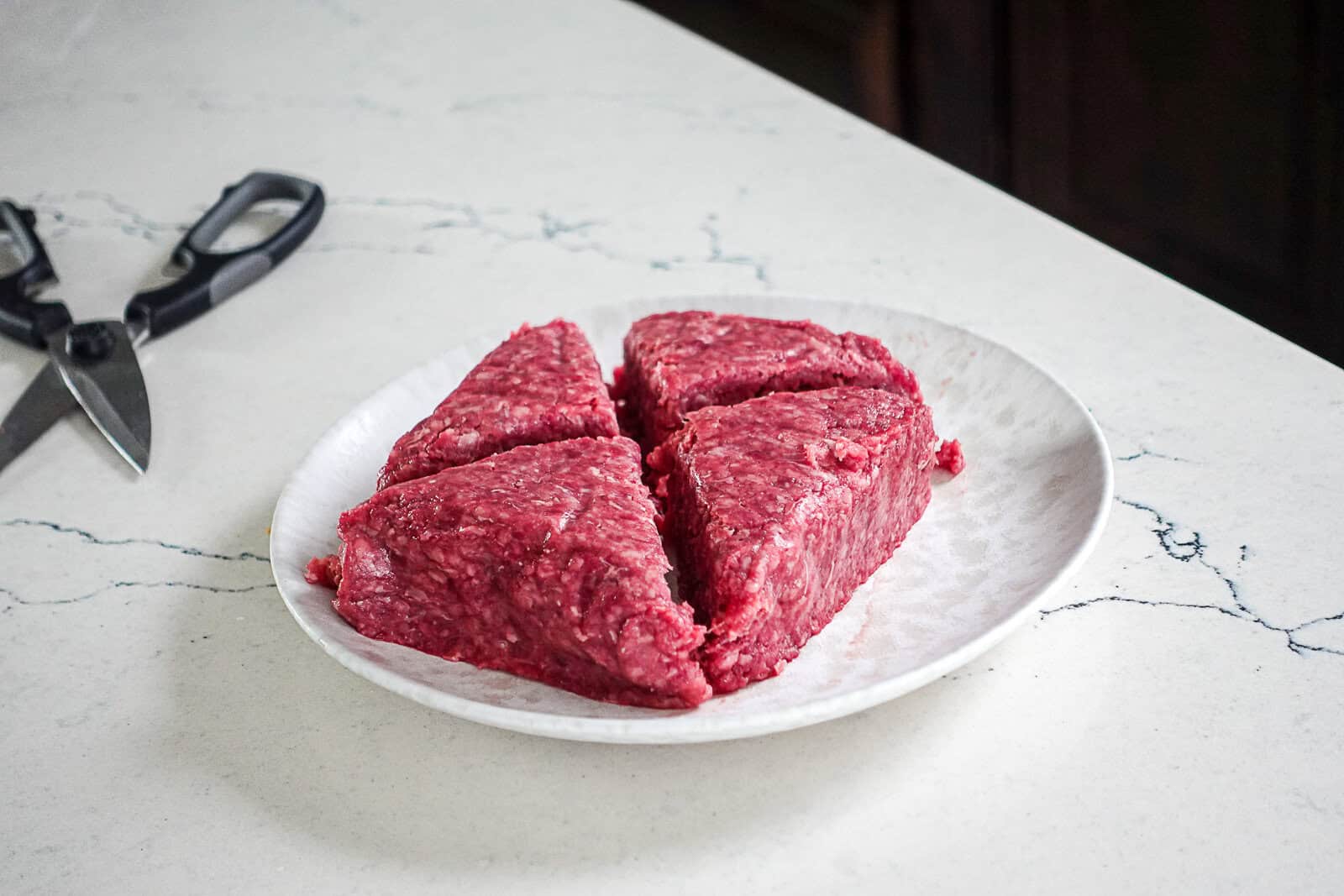 Ground burger meat divided into quarter pound sections