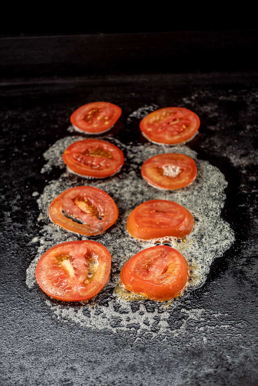 Tomatoes Cooking On Griddle Flattop