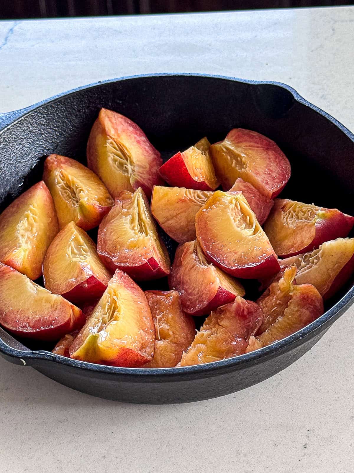 Sliced Fresh Peaches in Cast iron skillet
