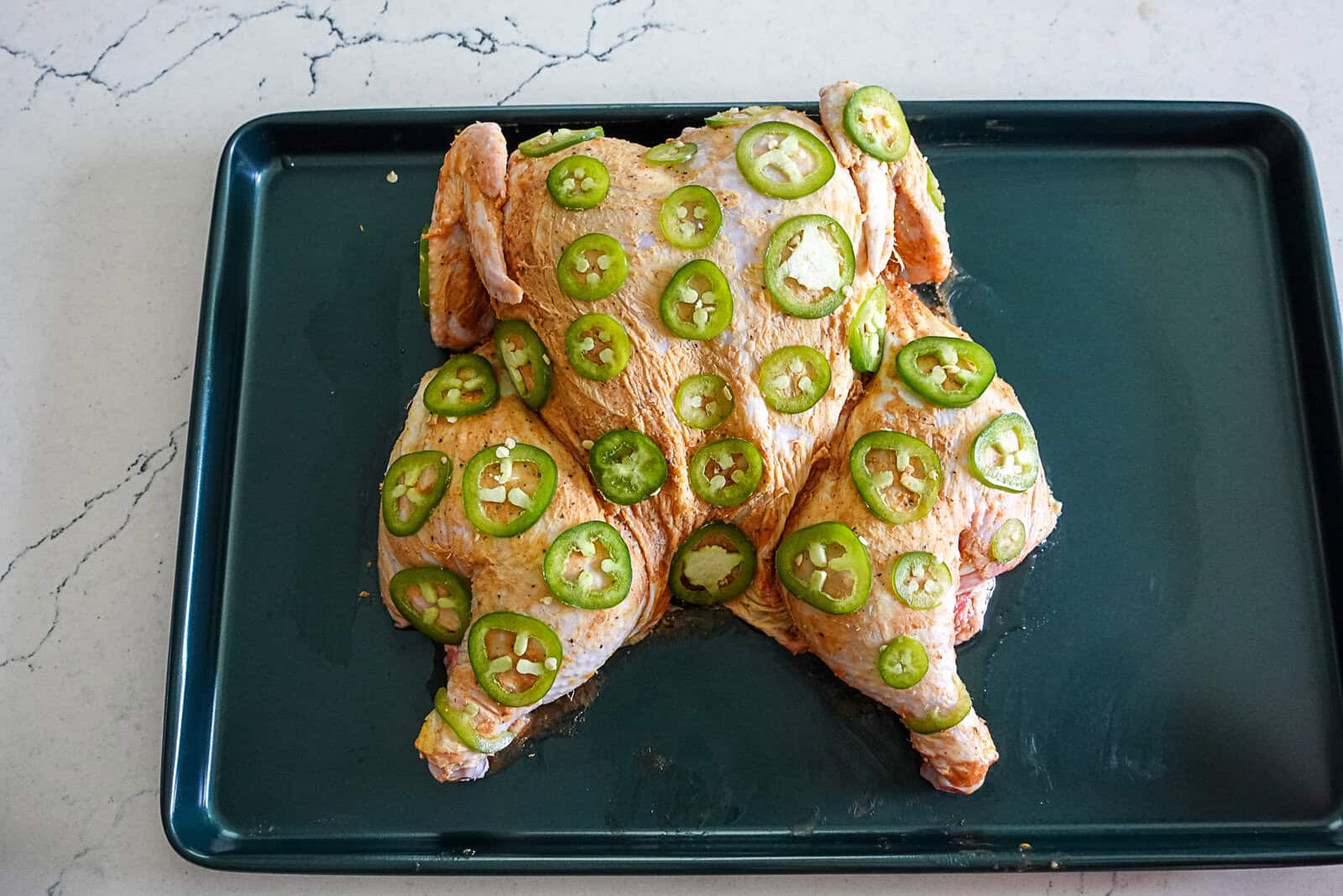 Spatchcock Chicken with slices of Jalapenos