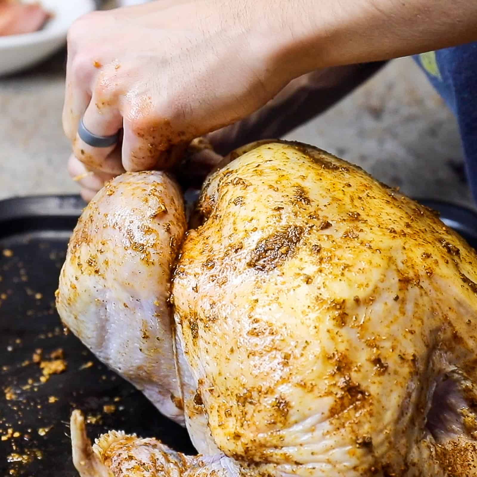 Chilling a seasoned whole turkey in the fridge before smoking