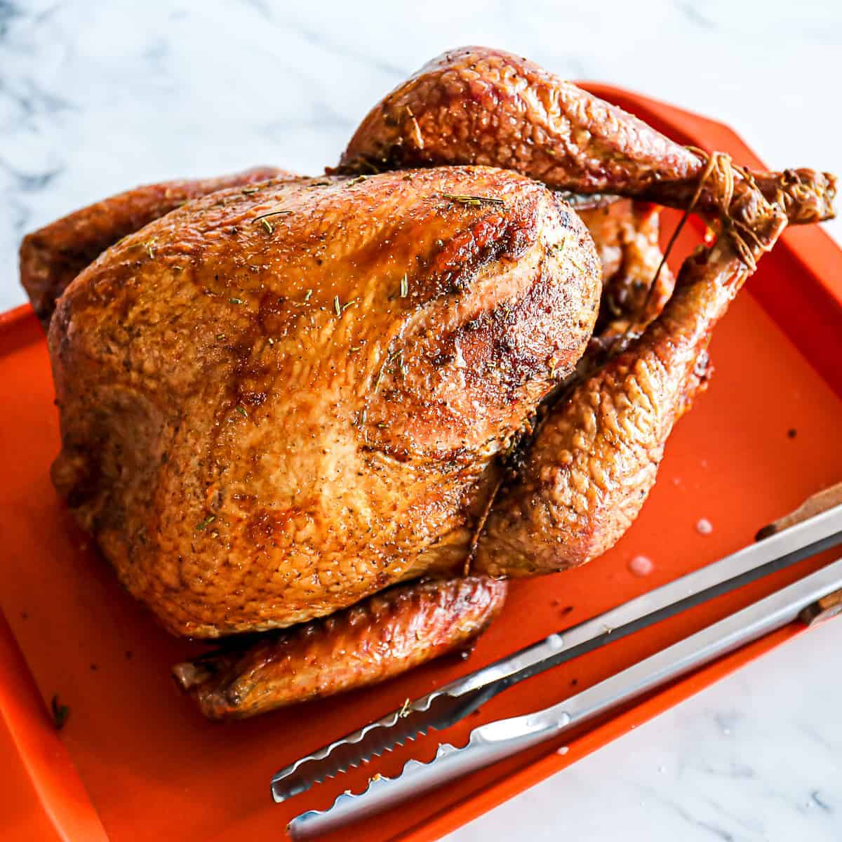 Smoked whole turkey on tray