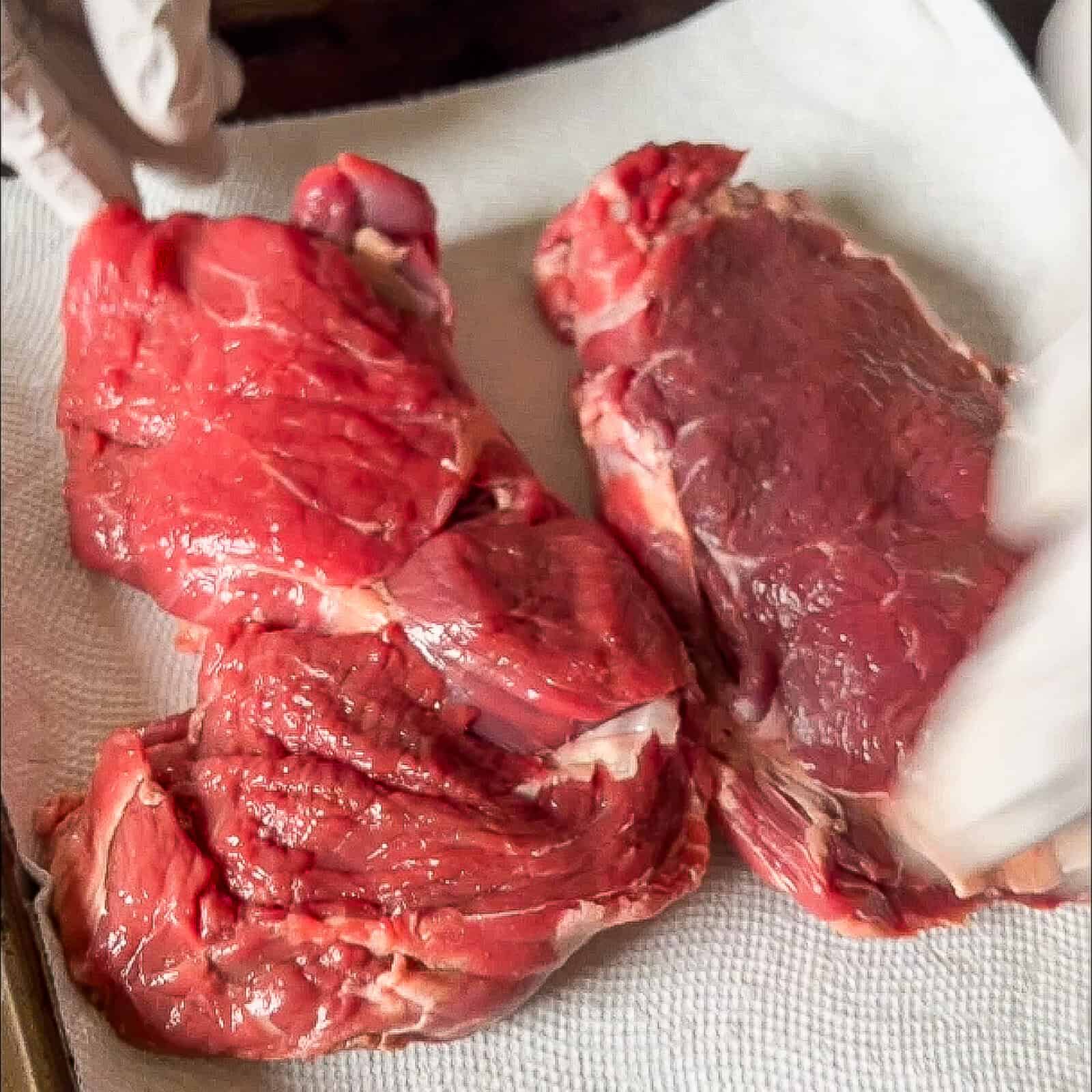 Checking ribeye temperature with thermometer, seared crust