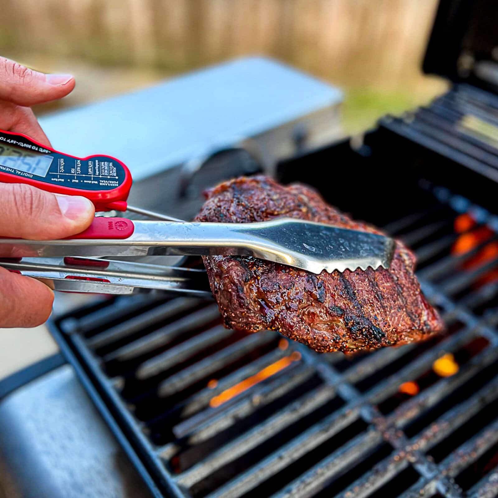 Patting ribeye steaks dry with paper towels