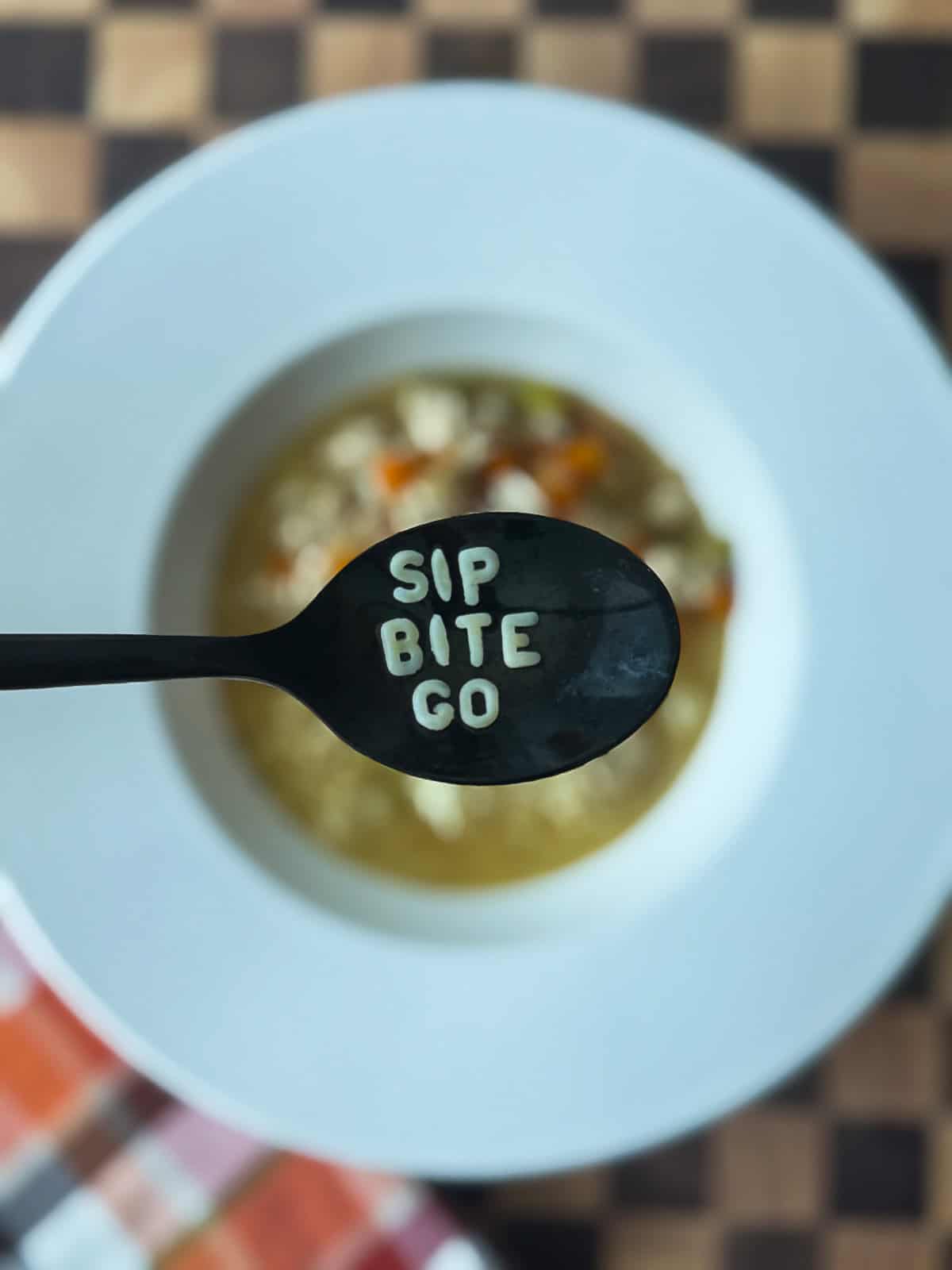 Close-up of egg noodle pasta in a bowl of homemade chicken noodle soup