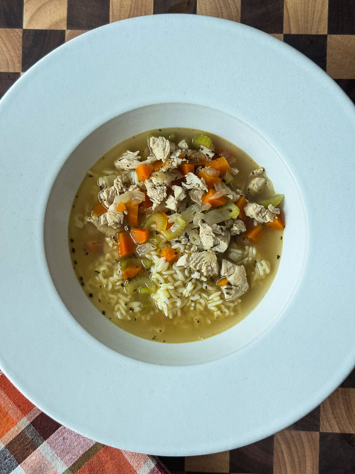 Homemade chicken noodle soup with vegetables and alphabet egg noodles served in a bowl