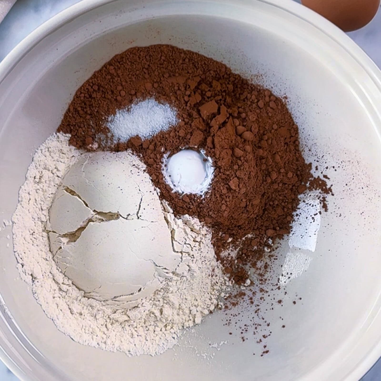 Mixing dry ingredients for chocolate banana bread loaf in a bowl