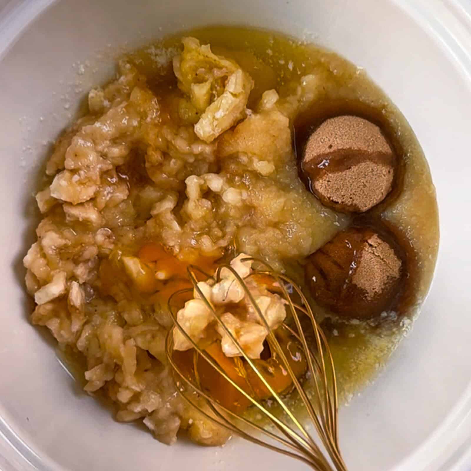 Preparing wet ingredients for chocolate banana bread with mashed bananas