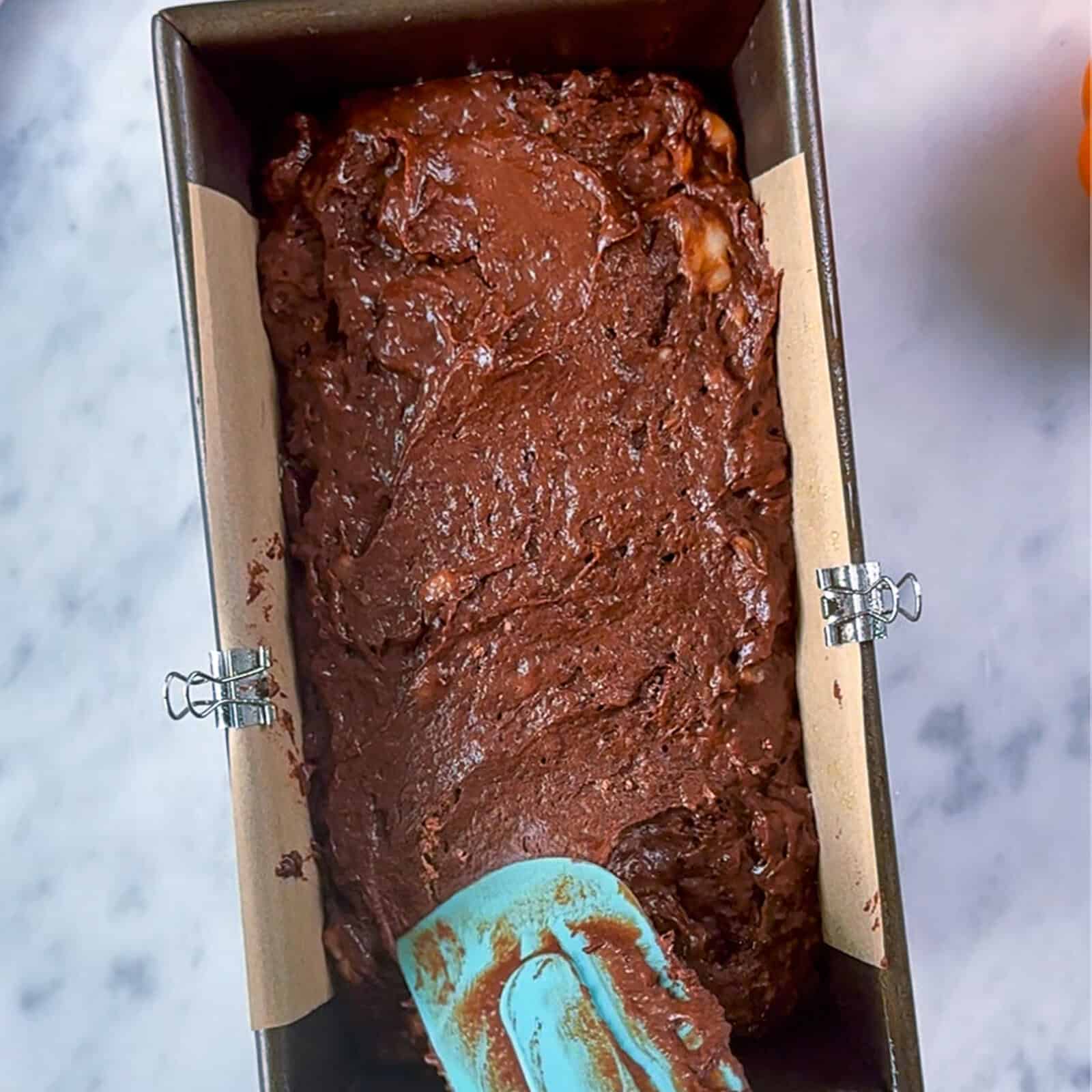 Assembling the batter for chocolate banana bread loaf in a mixing bowl