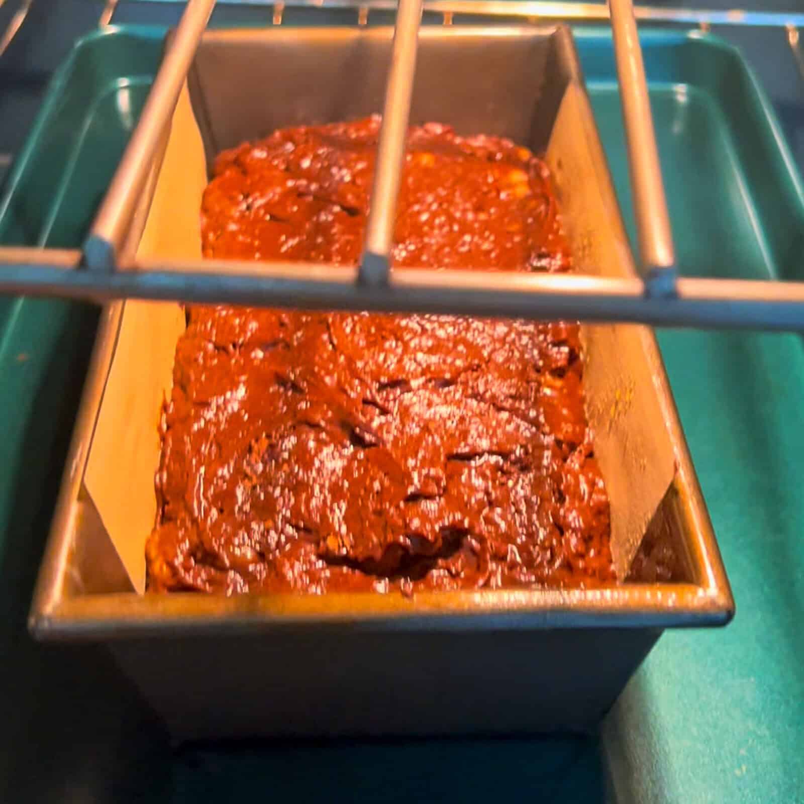 Baking chocolate banana bread loaf in a loaf pan in the oven