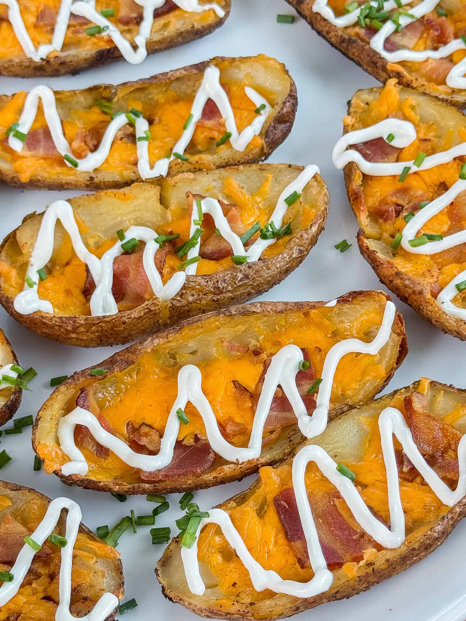 cheesy Traeger smoked potato skins topped with bacon