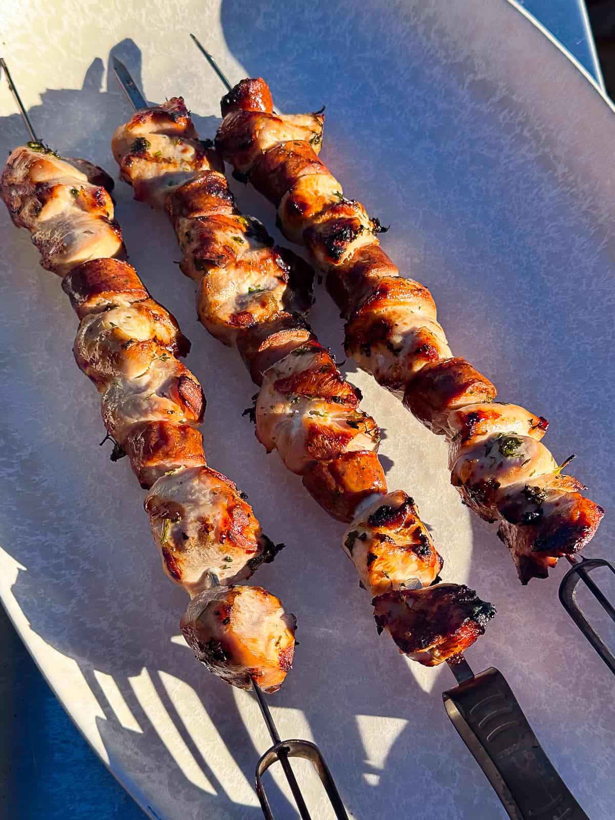 GRILLED Italian Chicken Kebabs on skewers on platter