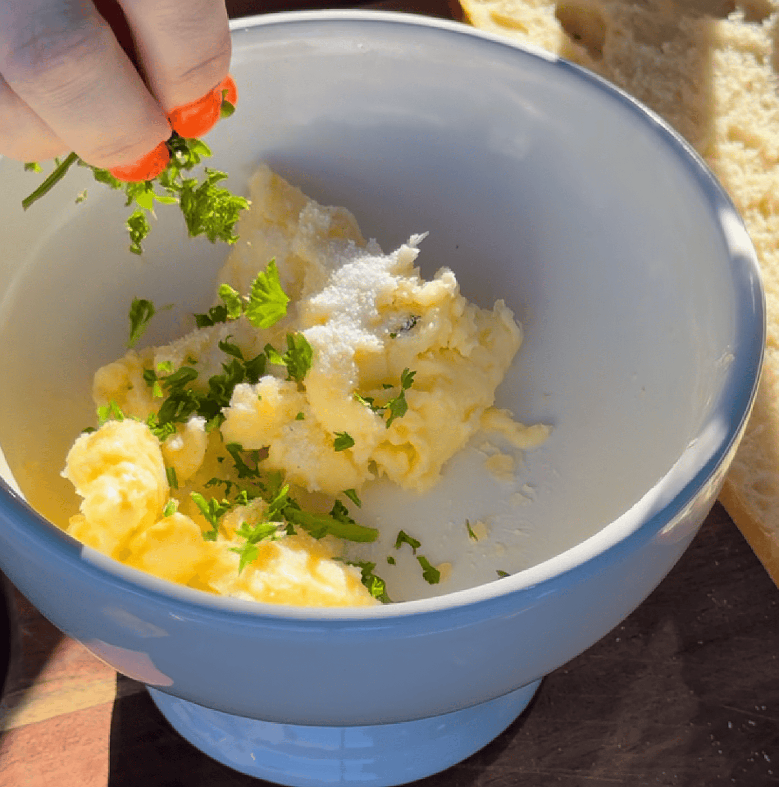 Making garlic butter with parsley