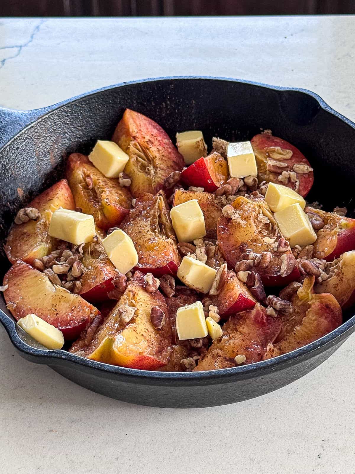 Smoked Peaches prepared for dessert in cast iron skillet