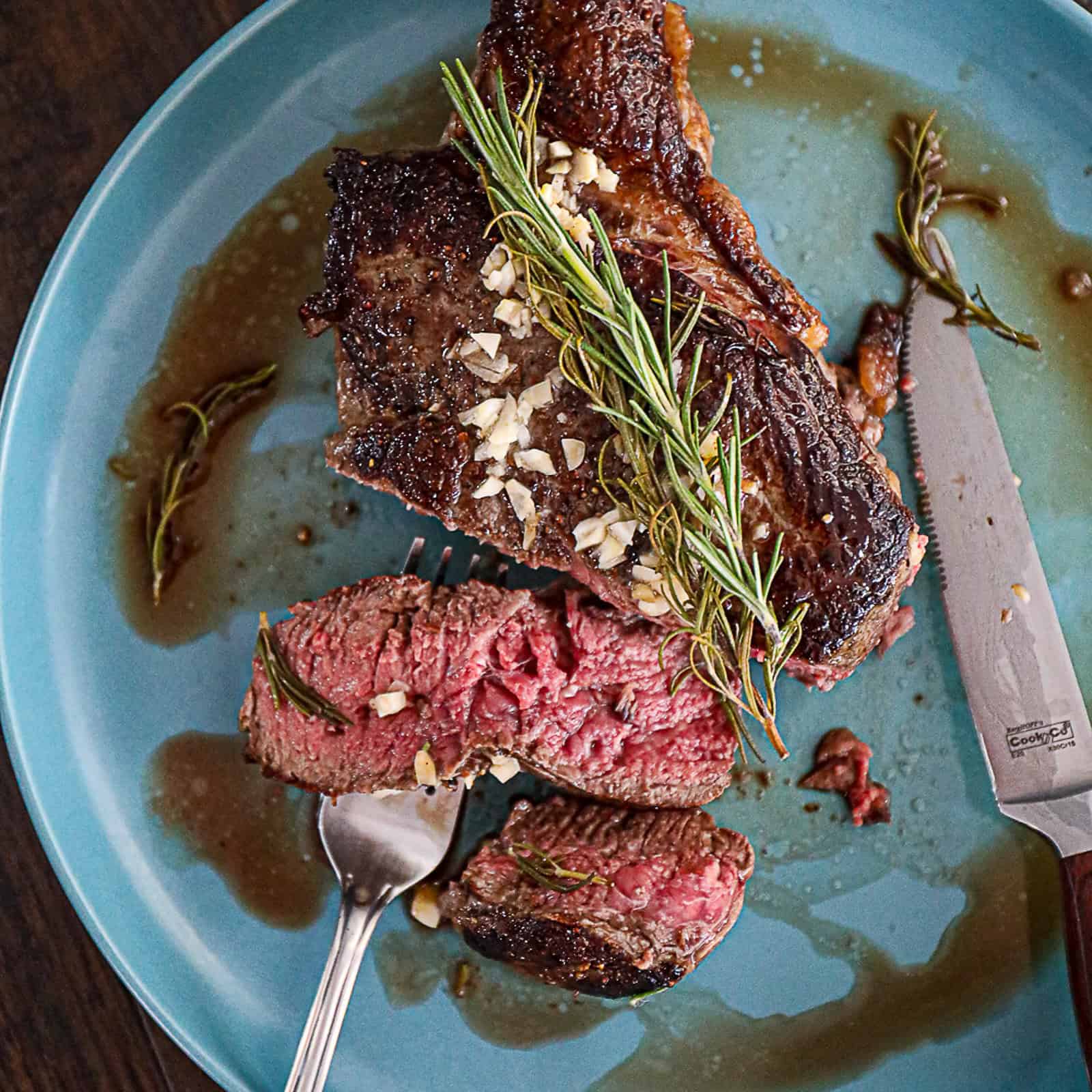 Serving slices of cooked top sirloin steak on a plate