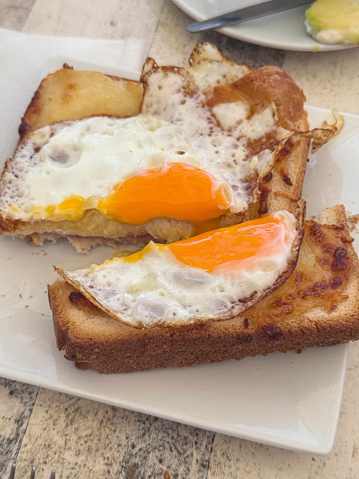 Close-up of breakfast sandwich with fried egg, ham, and cheese at Good Morning Café in St. Maarten