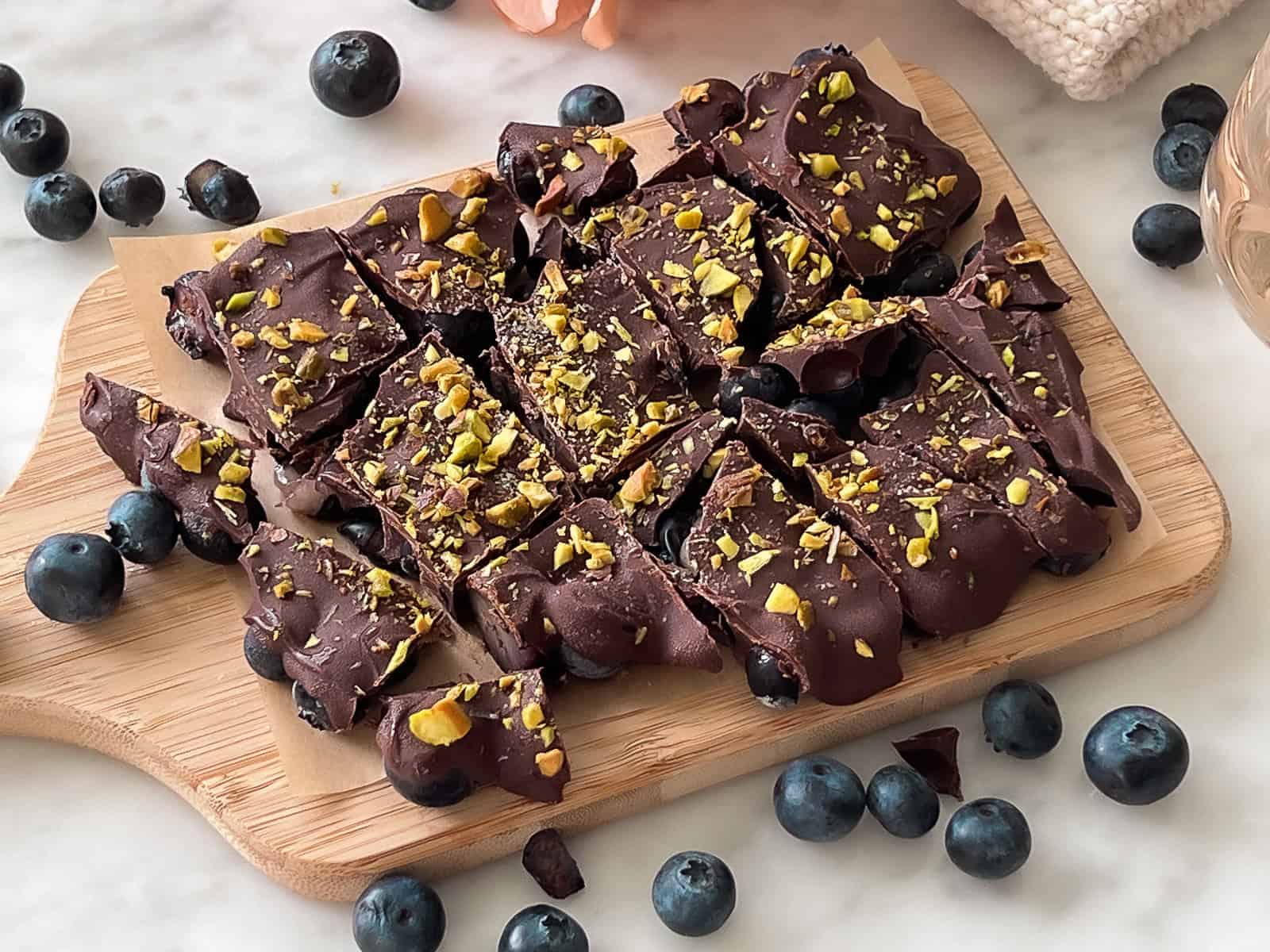 Serving tray with frozen chocolate blueberry bites and fresh fruit