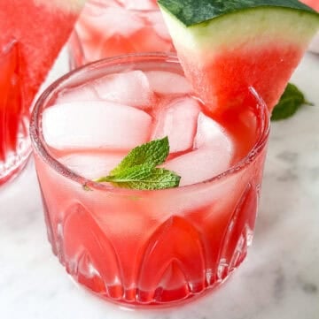 Watermelon cucumber gin cocktail served with a sprig of fresh mint