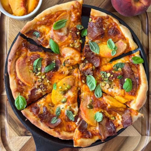 Slice of peach and bacon pizza on a plate