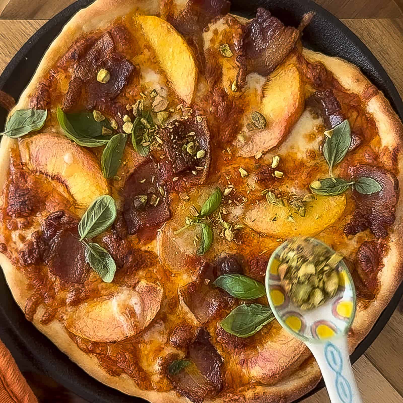 Finishing and garnishing peach and bacon pizza