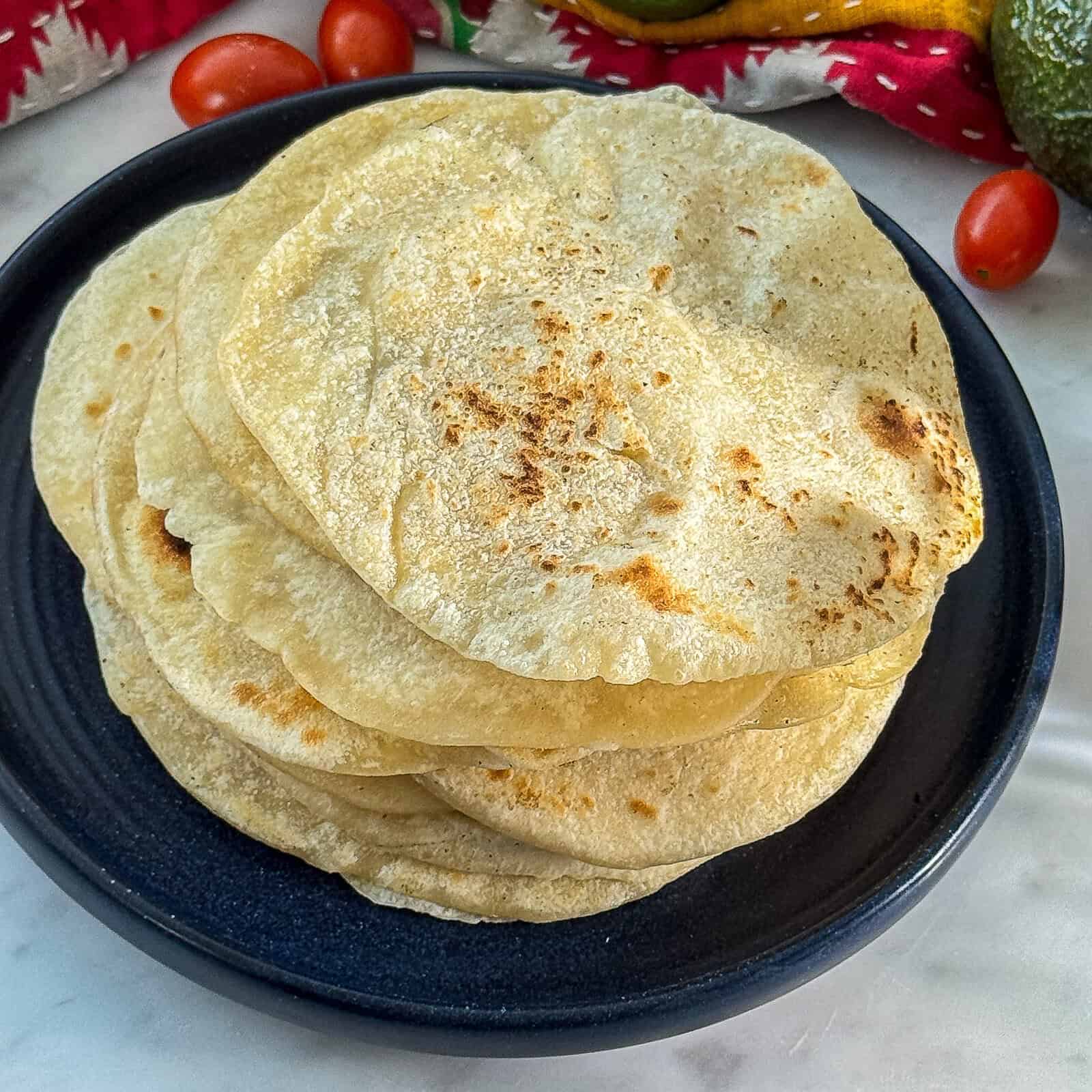 batch of homemade butter tortillas stacked and ready to serve