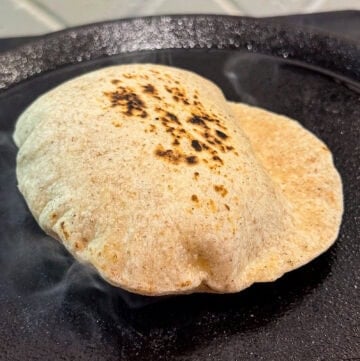 butter tortillas cooking on a cast iron skillet