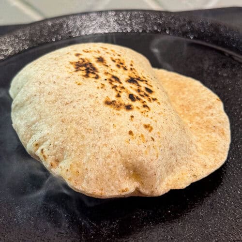 butter tortillas cooking on a cast iron skillet