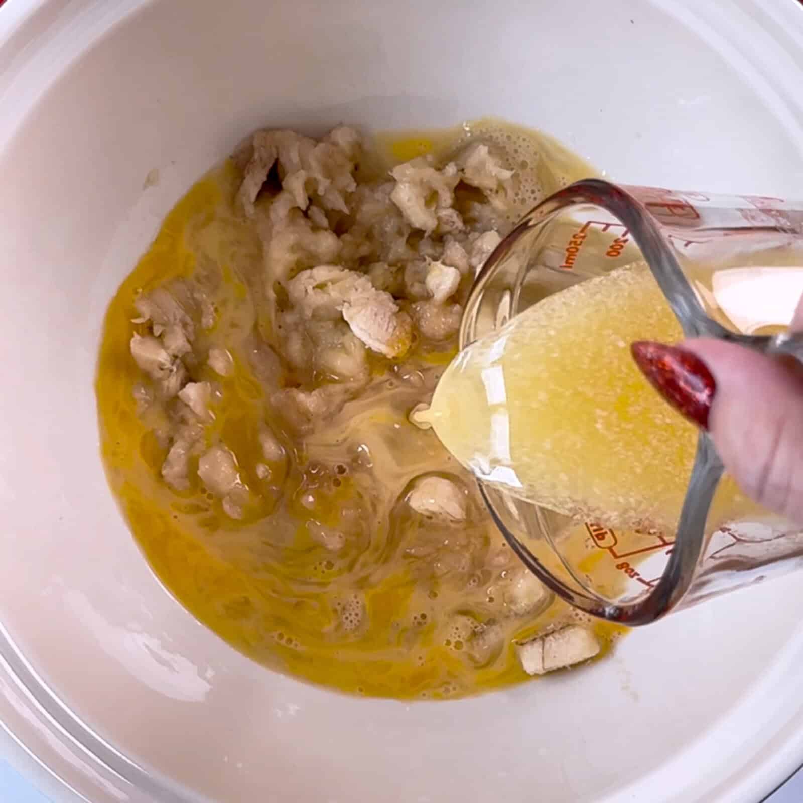 stirring eggs, vanilla, butter, and mashed bananas for wet ingredients