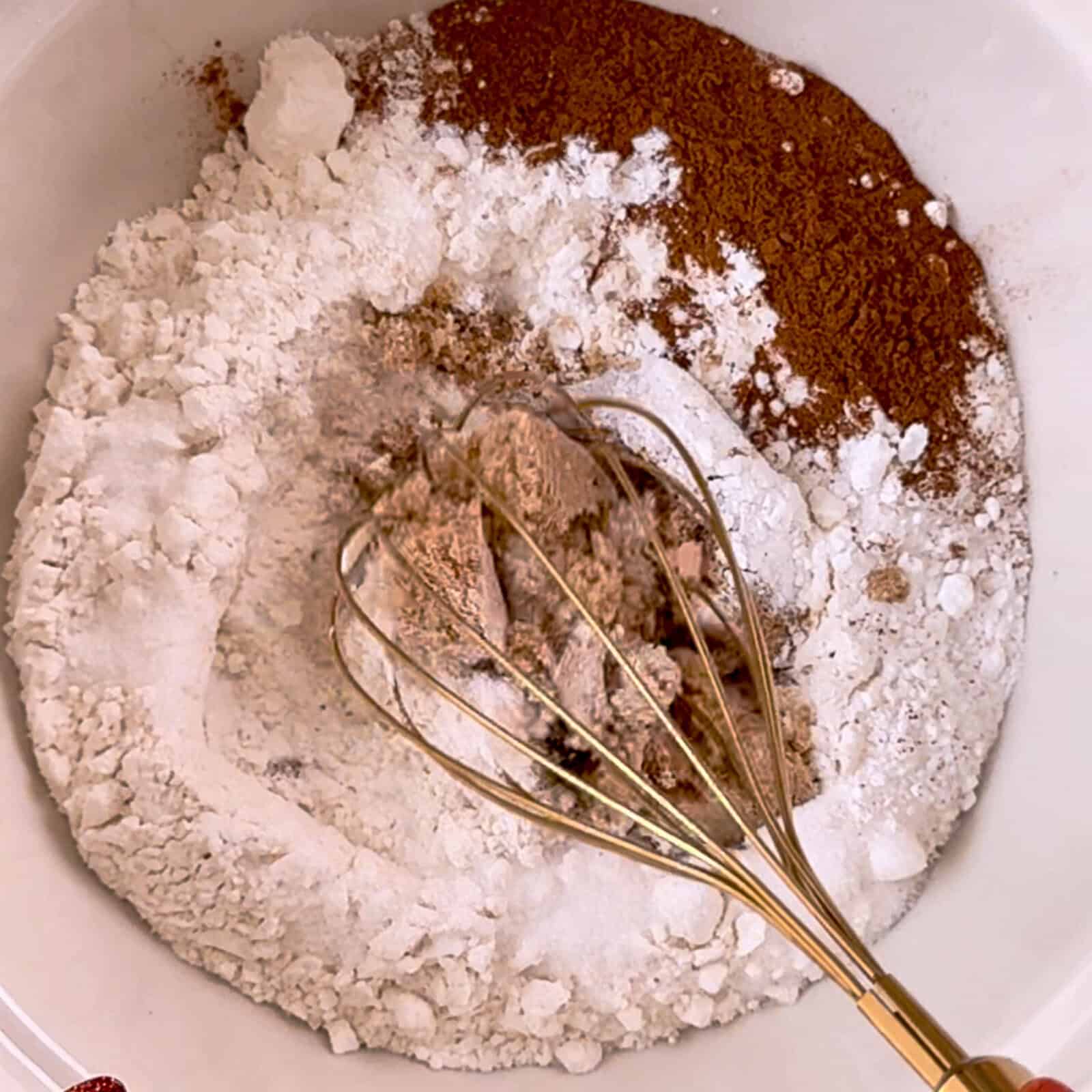 mixing flour, sugar, and cinnamon together for dry ingredients