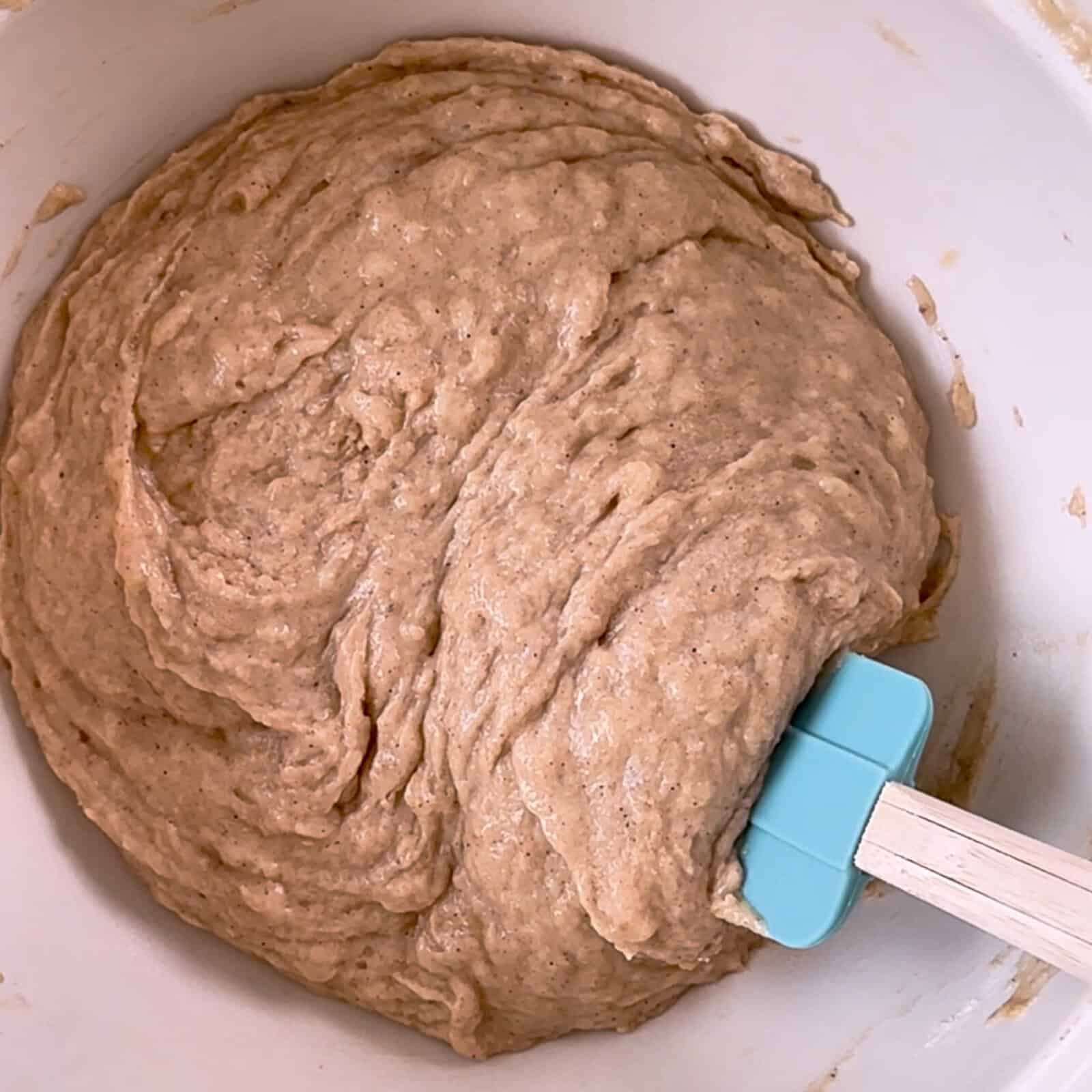 banana bread batter in a mixing bowl before adding apples