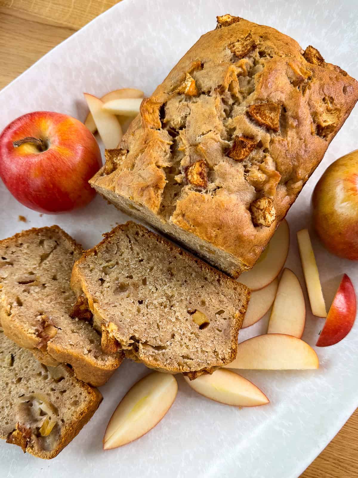 brunch dessert tray with sliced cinnamon apple banana bread and fresh apples