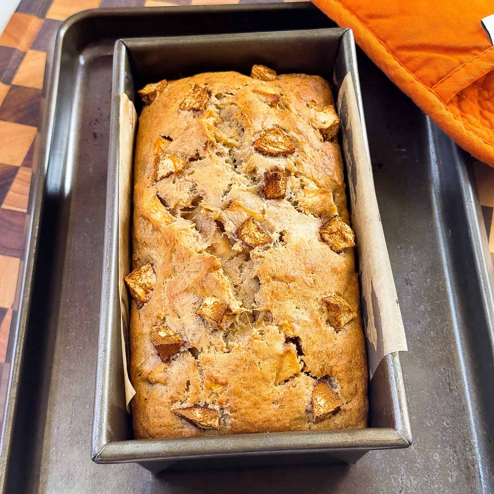 cinnamon apple banana bread cooling in a loaf pan after baking