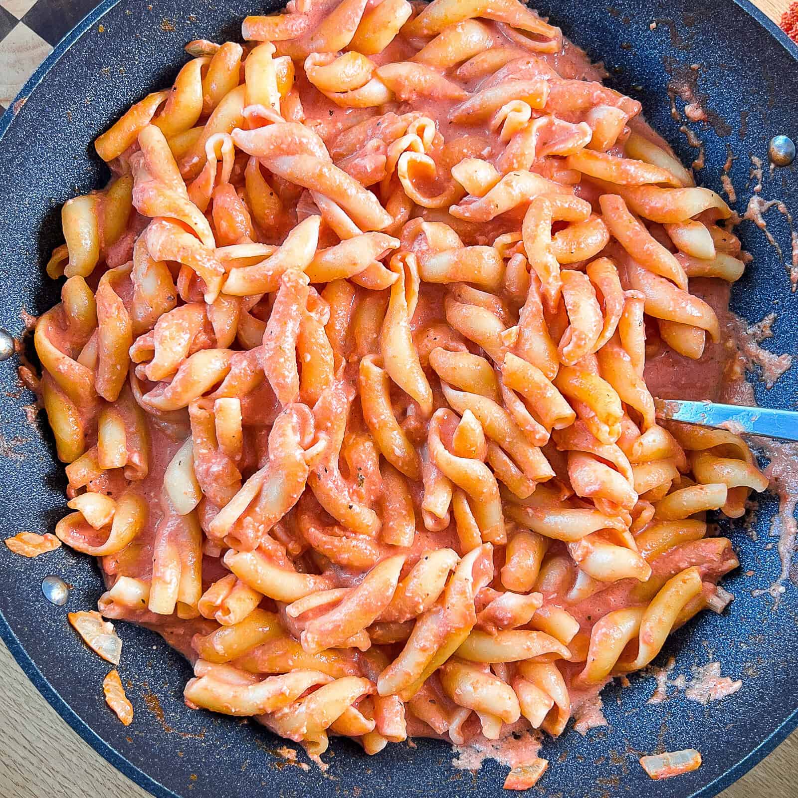 Creamy tomato mozzarella sauce served over pasta in a bowl