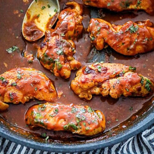 Finished dish of easy chicken simmered in enchilada sauce served on a plate