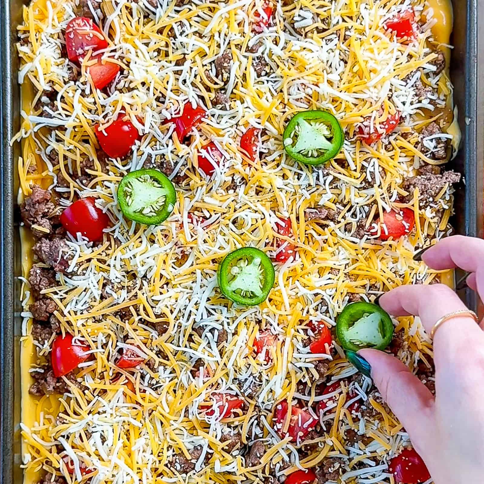 Adding toppings to viral sheet pan nachos