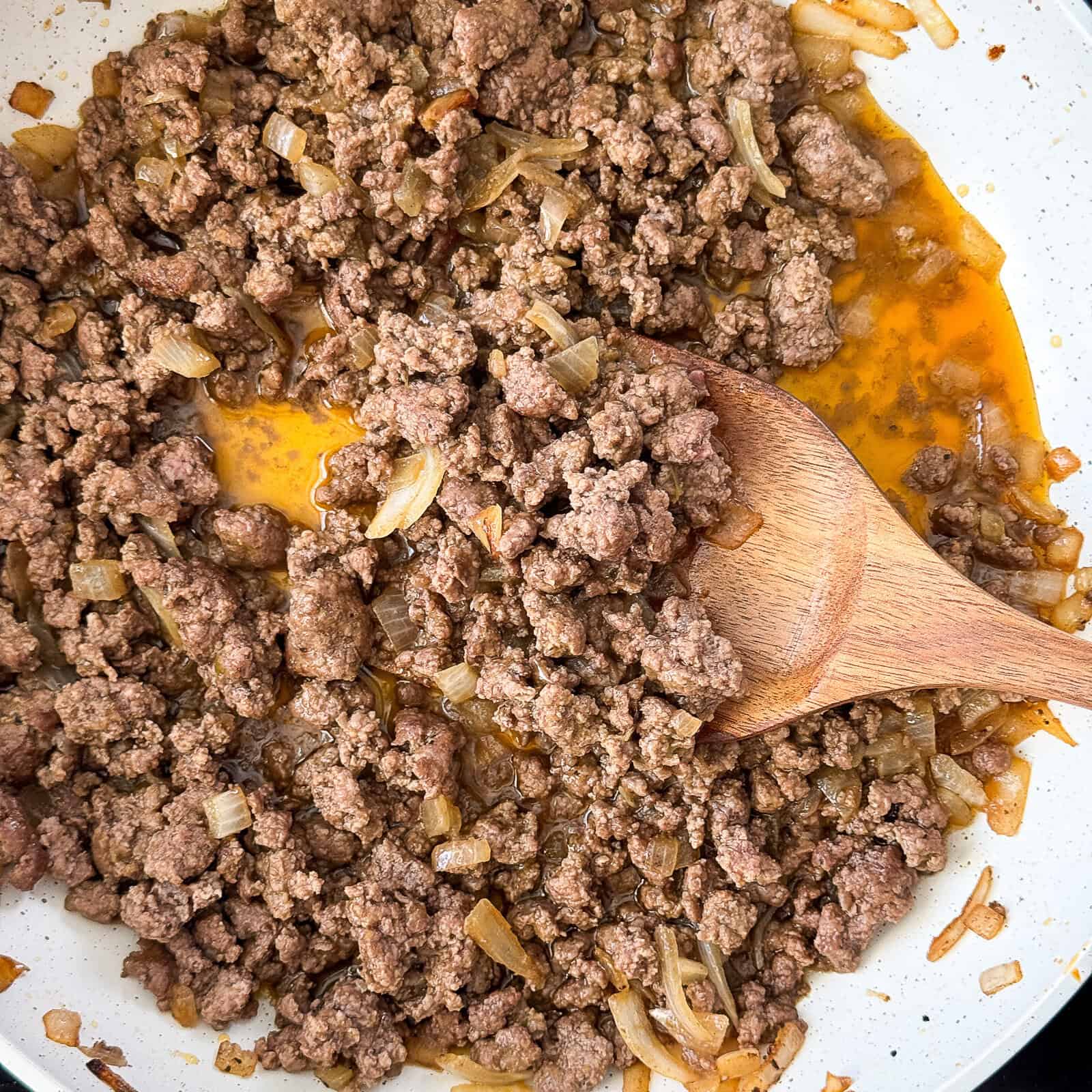 Browned ground beef cooked for tacos in a skillet