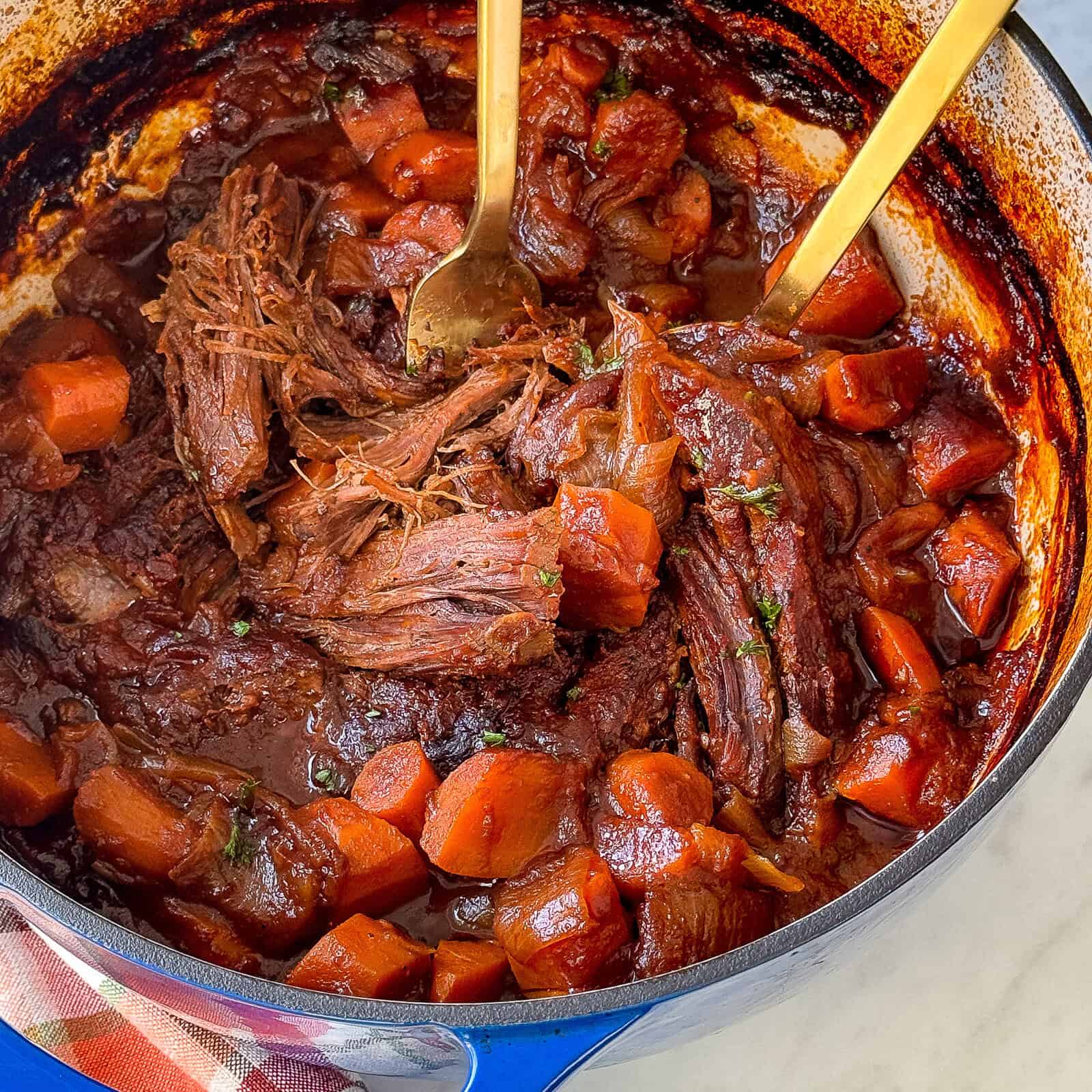 Shredded Guinness pot roast beef in a serving dish