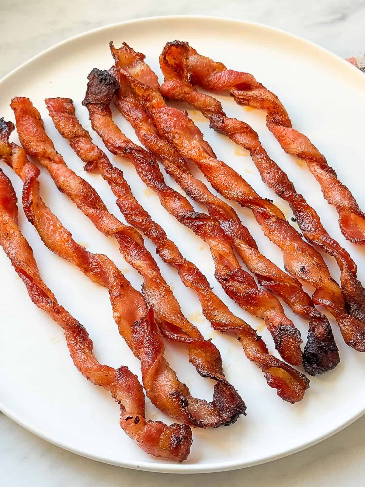 Side dish featuring golden, BBQ-seasoned twisted bacon cooked in the oven