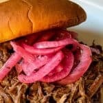 Slow Cooker BBQ shredded beef sandwich recipe with text overlay