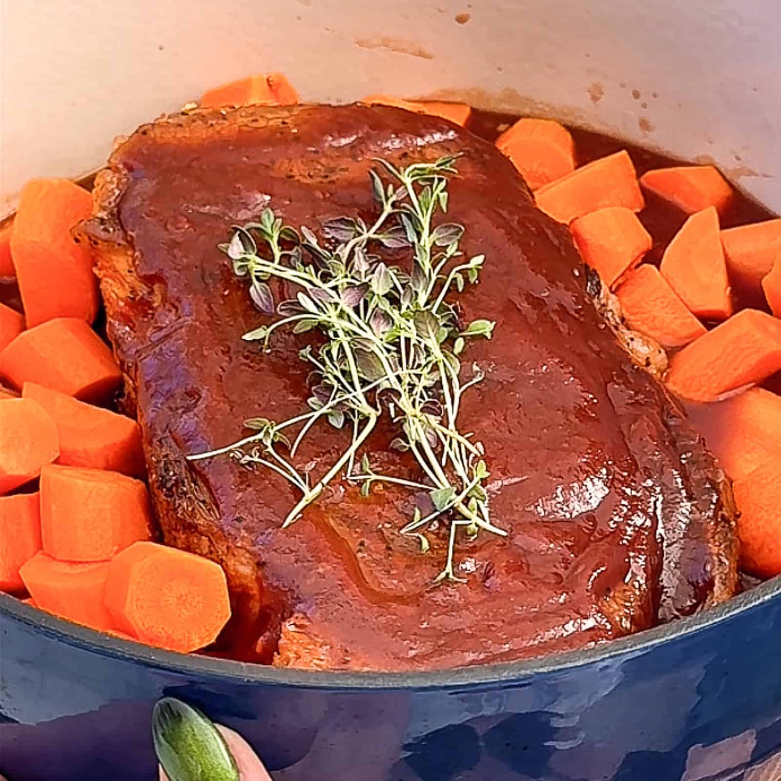 Ingredients for Guinness pot roast being assembled in a Dutch oven