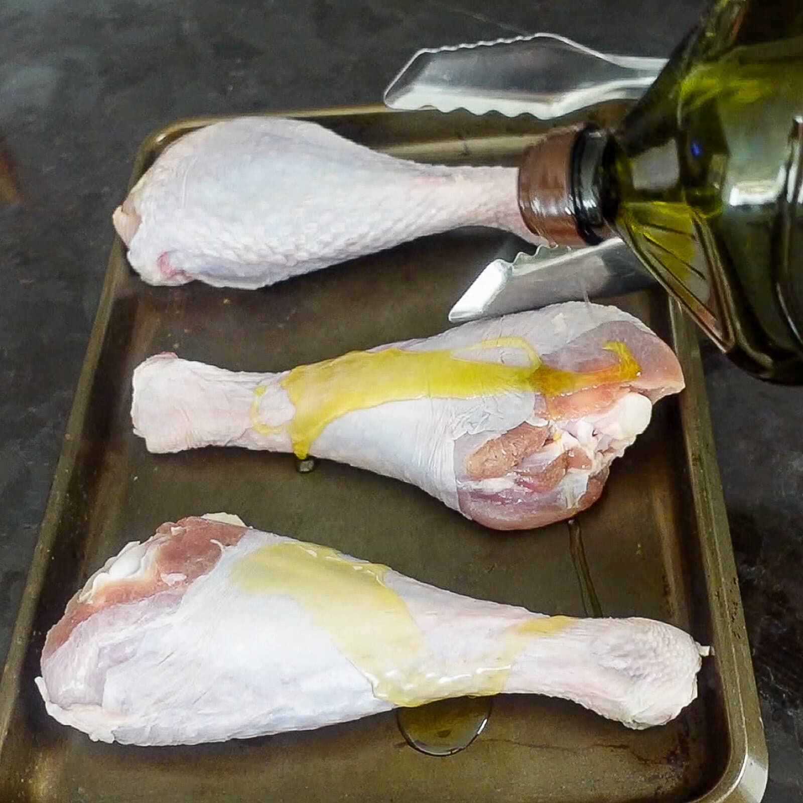 drizzling olive oil on raw turkey legs