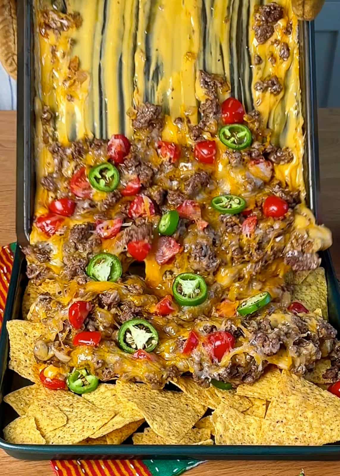 Viral nachos with sliding cheese on a baking sheet