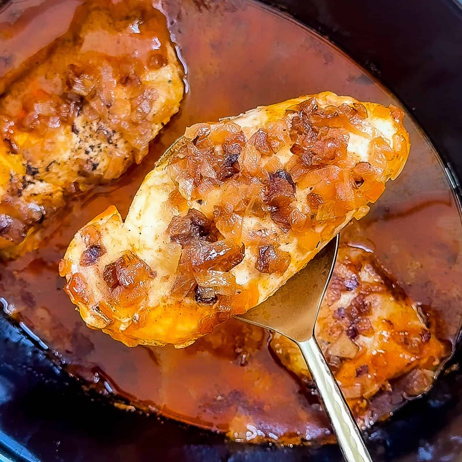Adding partially cooked butter chicken into crockpot with sauce