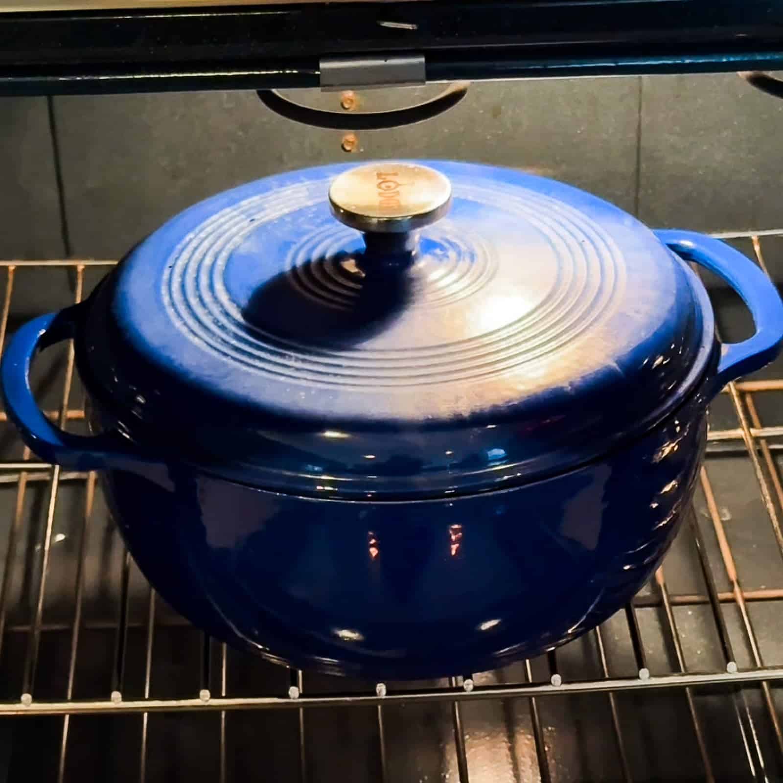 Dutch oven inside the oven cooking a pot roast